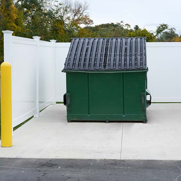 large green commercial dumpster for trash and recycling